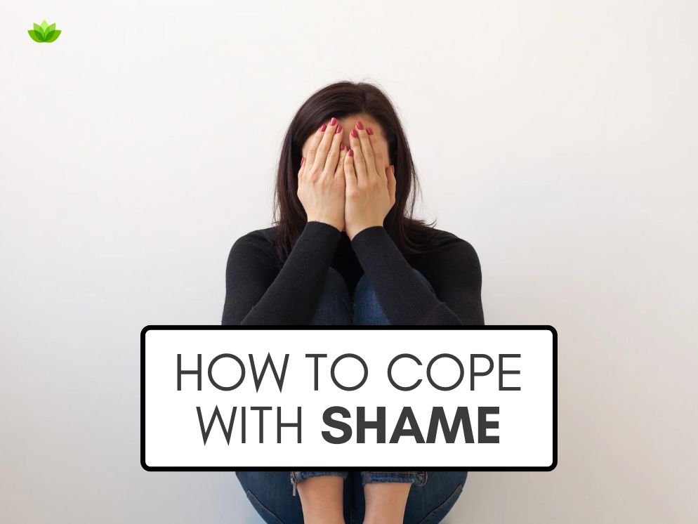 A graphic that reads how to cope with shame over a stock photo of a white woman wearing all-black sitting against a white background with her hands covering her face.