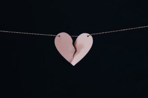 image of a ripped paper heart on a string